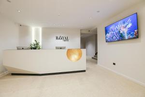 a museum room with a large white counter and a television at Royal Regency Eg Hotel in Cairo