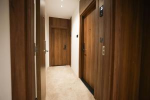 a hallway with two wooden doors and a carpeted floor at Royal Regency Eg Hotel in Cairo