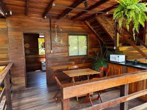 a dining room with wooden walls and a table at Hotel e Restaurante Tribo Combú in Belém