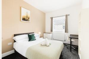 - une chambre avec 2 lits et un bureau dans l'établissement Contractors-Sleeps 7-FreeWiFi-CityCentre, à Spon End