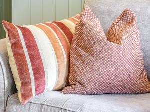 two pillows sitting on top of a couch at Stable Cottage - E5118 in West Burton