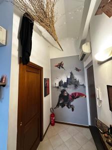a hallway with a door and a poster on the wall at La casa magica in Cuggiono
