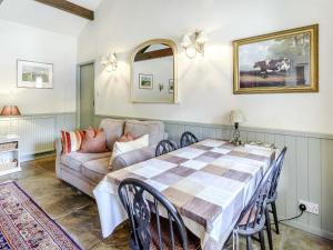a living room with a table and a couch at Stable Cottage - E5118 in West Burton +25 photos