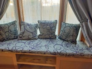 a bench in a window with pillows on it at Divers Cottage in Herne Bay