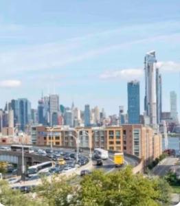 a view of a city with traffic on a highway at designer abode condo min to Manhattan in jersey city in Jersey City