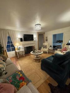 a living room with a couch and a fireplace at 5 BR 4 Bath Dutch Cottage 3 ml from Buffalo Trace in Frankfort