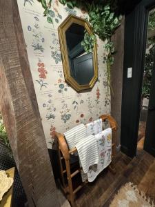 a mirror on a wall next to a chair at 5 BR 4 Bath Dutch Cottage 3 ml from Buffalo Trace in Frankfort