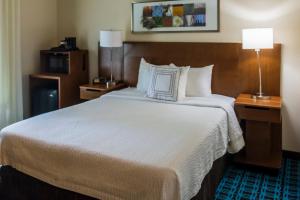 a hotel room with a large bed with white sheets at Okatie Hilton Head Hotel in Bluffton