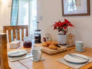 a table with croissants and a plate of food on it at Long Barn - Uk30435 in Kingsbury Episcopi