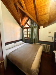 a bedroom with a large bed with a wooden ceiling at Why Not Guemes in Córdoba +49 photos