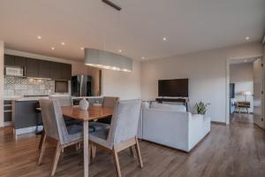 a kitchen and living room with a table and chairs at Elegante apartamento 3 recamaras Juriquilla in Juriquilla