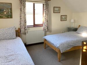 a bedroom with two beds and a window at Pheasant in Welney +8 photos