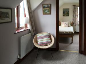 a small room with a chair and a bedroom at Pheasant in Welney