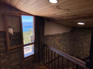 a room with a balcony with a large window at Casa Narcís in Claverol