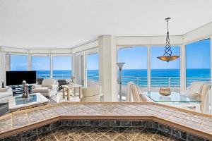 a living room with a view of the ocean at Spacious Three-Bedroom Oceanfront Apartment with Panoramic Views in Pompano Beach