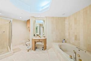 a large bathroom with a tub and a sink at Spacious Three-Bedroom Oceanfront Apartment with Panoramic Views in Pompano Beach +26 photos