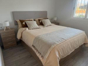 a bedroom with a large bed with two lamps on it at Mirador del Sol - Sea View Apartment Torrox in Torrox +14 photos