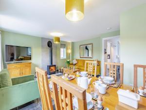 a kitchen and dining room with a table and chairs at Humbug House in Lower Soudley