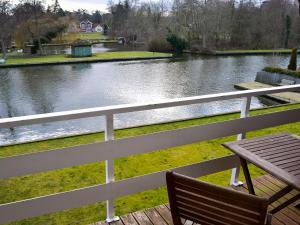 a view of a river from a balcony with a table at The Wherry in Wroxham