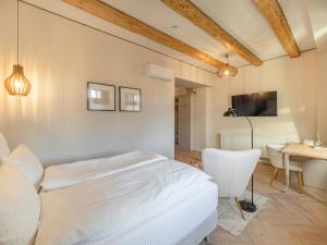 a bedroom with a bed and a table and a desk at Casa Breslelor in Sibiu