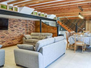 a living room with two couches and a dining room at The Old Stables in Tickton +35 photos