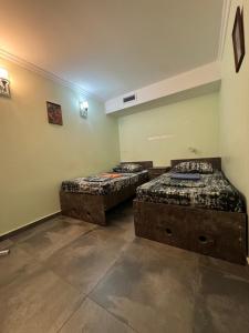 two twin beds in a room with at Hostel VOYAGE in Batumi