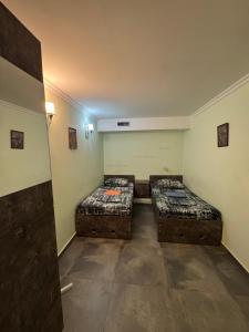 an empty room with two beds in it at Hostel VOYAGE in Batumi