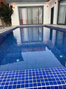 a swimming pool with blue tiles in a building at Villa karya in Kas