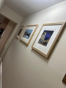 three framed photographs on a wall in a room at Dotty Apartment in Birtley