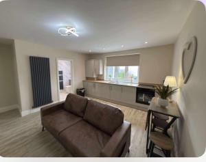 a living room with a couch and a table at Dotty Apartment in Birtley