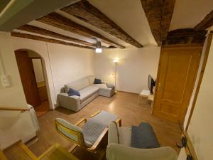a living room with a white couch and chairs at Casa Narcís in Claverol