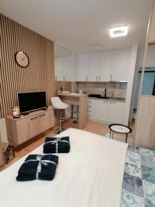 a bedroom with a bed with two pillows on it at Apartman Pahuljica in Pale