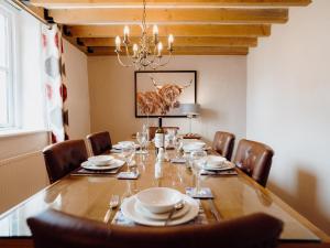 a dining room with a long table and chairs at St David's Lodge - Uk6738 in Lydstep