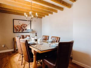 a dining room with a table with chairs and a chandelier at St David's Lodge - Uk6738 in Lydstep