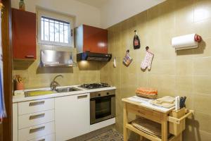 a small kitchen with a stove and a sink at Residenz Roccolo in Ghiffa +22 photos