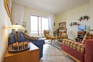 a living room with a couch and a table with a chessetts at Residenz Roccolo in Ghiffa
