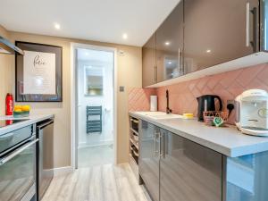 a kitchen with a counter top and a sink at Vitamin Sea Residency in Herne Bay