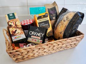 a basket filled with bread and other food items at Midcraigs in Kilchenzie
