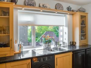 a kitchen with a sink and a window at Grooms Cottage in Choppington +15 photos