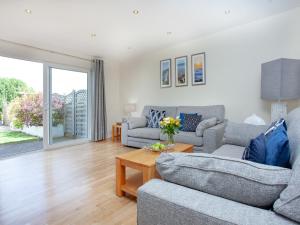 a living room with two couches and a table at Sundance in Cheriton Bishop