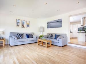 a living room with two couches and a table at Sundance in Cheriton Bishop