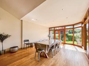a dining room with a table and chairs at Springfields in North Wootton