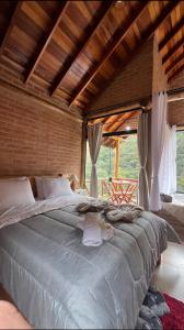 a bedroom with a large bed in a room at Chales Estância Verdejante in Sapucaí-Mirim