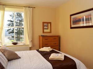 a bedroom with a bed with two towels on it at Bishop View in Braithwaite