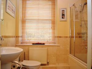 a bathroom with a toilet and a sink and a shower at Bishop View in Braithwaite