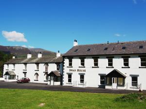 a large white building with a red car parked in front at Bishop View in Braithwaite +5 photos