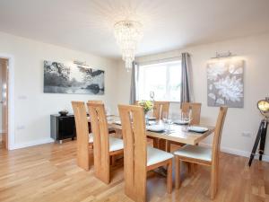a dining room with a wooden table and chairs at Sundance in Cheriton Bishop +37 photos