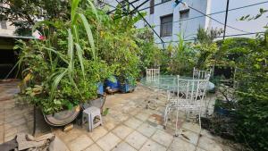 a patio with a table and a bunch of plants at Sky Garden Home in Dhaka