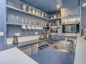 a large kitchen with a sink and a counter at The Berm - Uk41199 in Llanfynydd