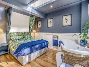 a bedroom with a bed and a bath tub at The Berm - Uk41199 in Llanfynydd +22 photos